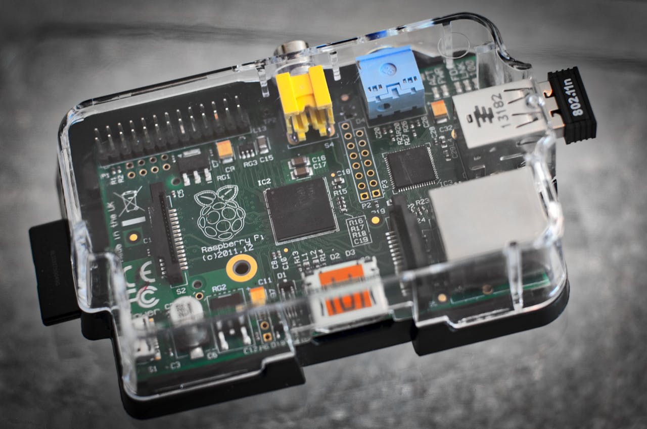 Detailed image of a Raspberry Pi microcomputer circuit board in a clear case.